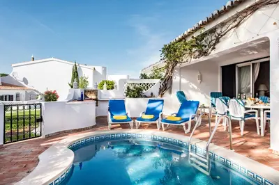 a patio with a pool and chairs and a table at Mng Elliott72 in Vale do Lobo