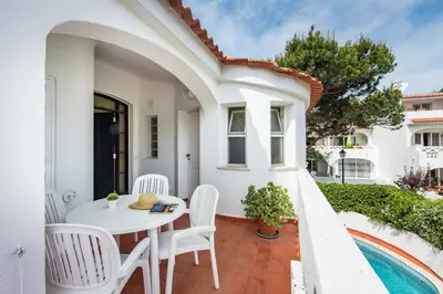 a white patio with a white table and chairs at Mng Elliott91c in Vale do Lobo