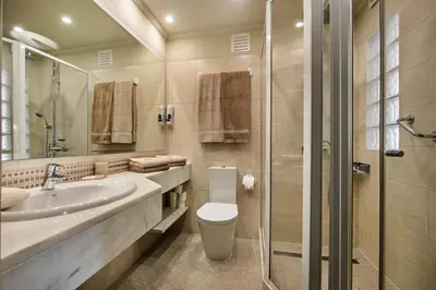 a bathroom with a toilet and a sink and a shower at Mng Elliott91c in Vale do Lobo