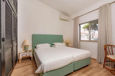 a bedroom with a large bed and a window at Mng Elliott91c in Vale do Lobo