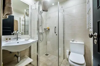 a bathroom with a shower and a sink and a toilet at Mng Elliott71 in Vale do Lobo