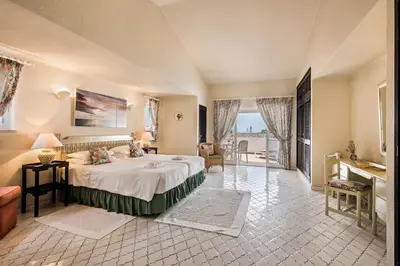 a large bedroom with a large bed and a balcony at Mng Elliott53 in Vale do Lobo