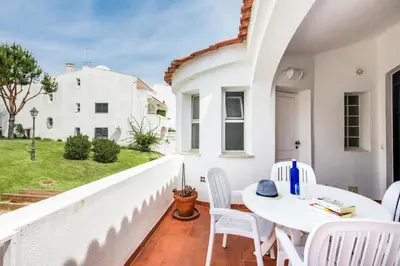 a white balcony with a white table and chairs at Mng Elliott90c in Vale do Lobo