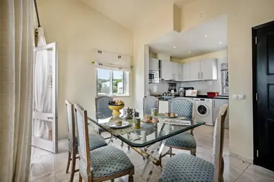 a living room with blue chairs and a fireplace at Mng Elliott90c in Vale do Lobo