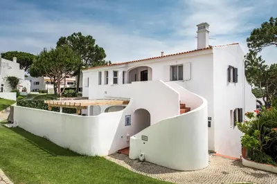 a white house with a spiral staircase at Mng Elliott90c in Vale do Lobo