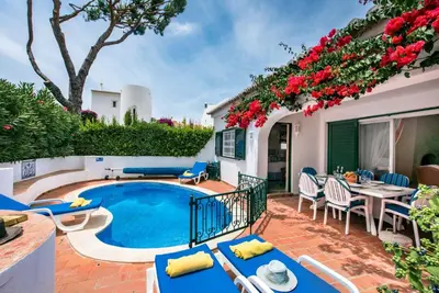 a patio with a pool and a table and chairs at Mng Elliott49 in Almancil