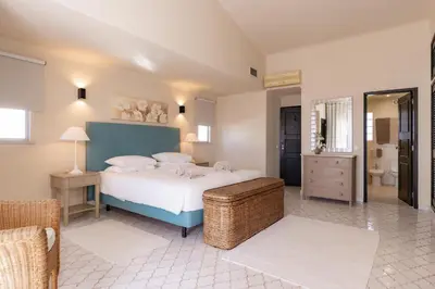 a bedroom with a large bed and a bathroom at Mng Elliott37 in Vale do Lobo