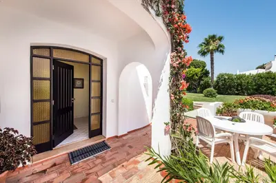 a dining room with a table and chairs at Mng Elliott46 in Vale do Lobo