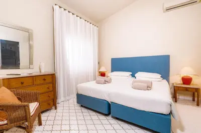 a blue and white bedroom with a bed and a chair at Mng Elliott46 in Vale do Lobo