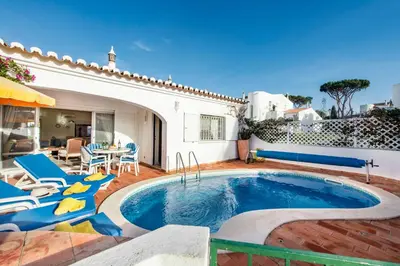 a patio with chairs and a swimming pool at Mng Elliott42 in Vale do Lobo