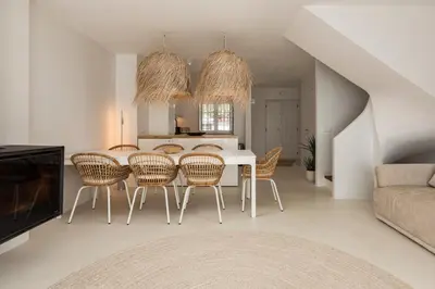 a dining room with a white table and chairs at Modern retreat 3 Bedroom in Vilamoura in Quarteira