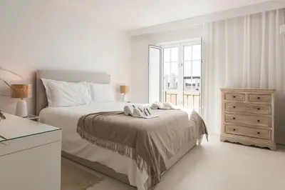 a white bedroom with a bed and a window at Modern retreat 3 Bedroom in Vilamoura in Quarteira