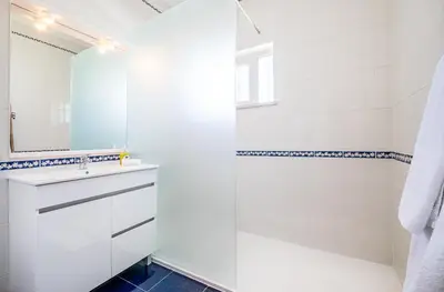 a white bathroom with a sink and a shower at Vicente Mar Luxury Villa - Private Pool in Albufeira
