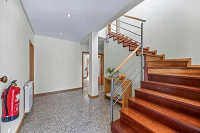 a staircase in a house with a red fire extinguisher at Tranquil Hideaway Olhos de Agua in Faro