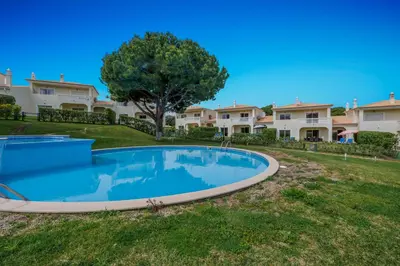 a large swimming pool in the yard of a house at Tranquil Hideaway Olhos de Agua in Faro