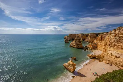 a view of a beach with rocks in the ocean at Tranquil Hideaway Olhos de Agua in Faro