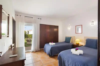 a bedroom with two beds with towels on them at Villa Aveiros in Albufeira