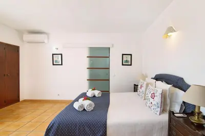 a bedroom with a bed with two stuffed animals on it at Villa Aveiros in Albufeira