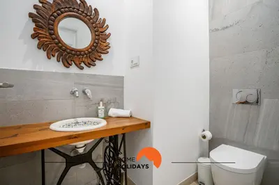 a bathroom with a sink and a mirror on the wall at #213 Vila Roja Pé by Home Holidays in Albufeira