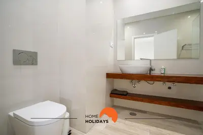 a bathroom with a toilet and a sink and a mirror at #213 Vila Roja Pé by Home Holidays in Albufeira