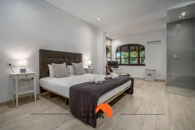 a bedroom with a bed with two teddy bears on it at #213 Vila Roja Pé by Home Holidays in Albufeira