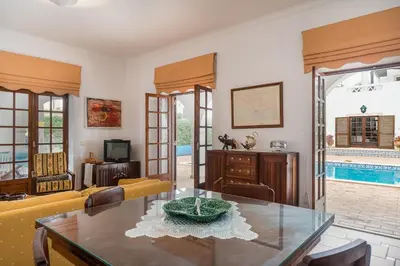 a living room with a table and a couch at Akisol Faro Relax in Faro
