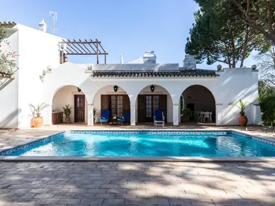 a swimming pool in front of a white house at Akisol Faro Relax in Faro