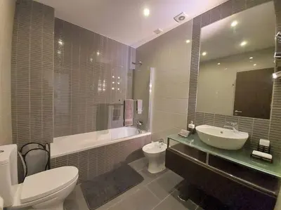 a bathroom with a sink and a toilet and a tub at Al Baltum in Albufeira