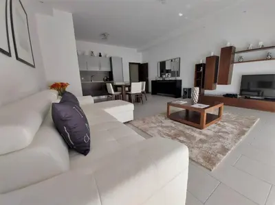a living room with a white couch and a table at Al Baltum in Albufeira