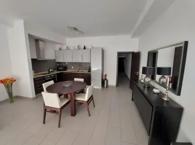 a kitchen and dining room with a table and chairs at Al Baltum in Albufeira