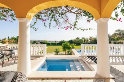 a house with a swimming pool and a white fence at TheBougainVilla our Oceanview Villa in the Hills in Boliqueime