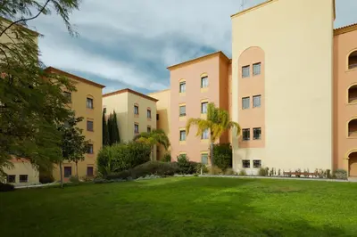 a row of apartment buildings with a grass field at The Residences Vilamoura in Vilamoura