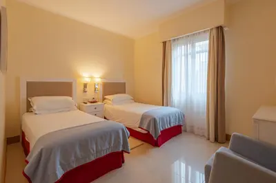 a hotel room with two beds and a window at The Residences Vilamoura in Vilamoura