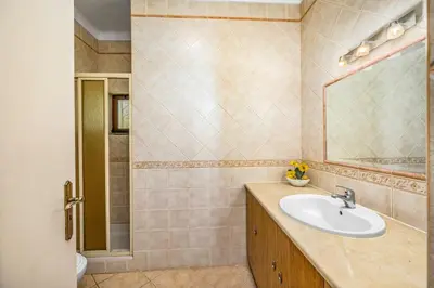 a bathroom with a sink and a mirror at Villa Casa Coelho by Villa Plus in Terras Novas