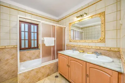 a bathroom with a sink and a tub and a mirror at Villa Casa Coelho by Villa Plus in Terras Novas