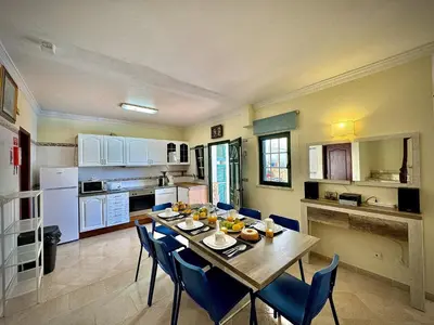 a dining room with a table and chairs in a kitchen at Albufeira Summer Villa 1 With Pool by Homing in Albufeira