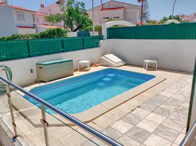 a small swimming pool on a patio with a fence at Villa GP by Sunny Deluxe in Albufeira