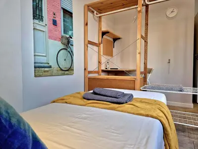 a bed with two towels on it in a room at Campus 121 - Rooms in Faro