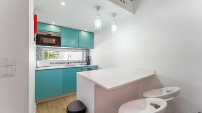 a bathroom with blue cabinets and a toilet and a sink at Relaxing Beach House in Alfamar by LovelyStay in Albufeira