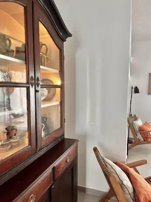 a wooden cabinet with dishes in it in a room at Casa Vale do Lobo in Vale do Lobo