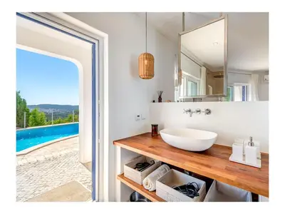 a bathroom with a sink and a mirror at Casa Monte Algarve Comfortable holiday residence in Loulé