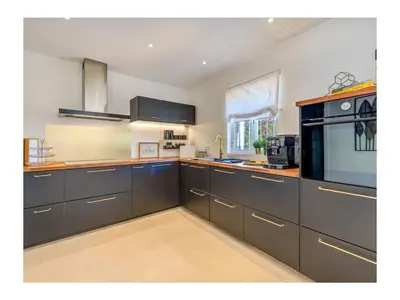 a large kitchen with gray cabinets and a window at Casa Monte Algarve Comfortable holiday residence in Loulé