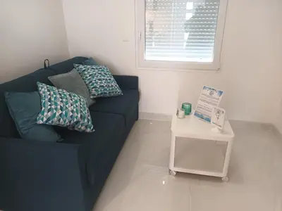 a white table with two chairs and a tv on the wall at Almar Studio - Albufeira - Praia dos pescadores in Albufeira
