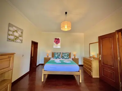 a bedroom with a bed and two dressers and a mirror at Albufeira Summer Villa 2 with Pool by Homing in Albufeira