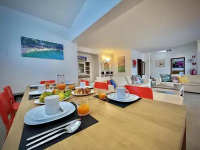 a dining room with a table with food on it at Albufeira Summer Villa 2 with Pool by Homing in Albufeira