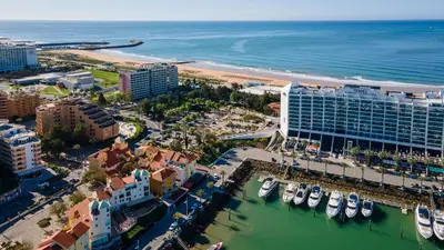 an aerial view of a resort and a harbor with boats at T3 Triplex Vista Mar Marina de Vilamoura-Greice Homes in Vilamoura