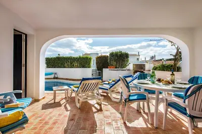 a white table and chairs on a patio at Mng Elliott55 in Vale do Lobo