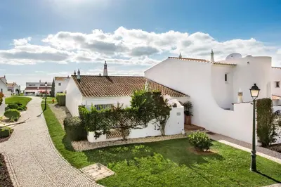 a large white house with a green yard at Mng Elliott55 in Vale do Lobo