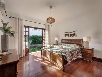 a bedroom with a bed and a wooden floor at Villa Vera VIP Properties by Interhome in Vilamoura