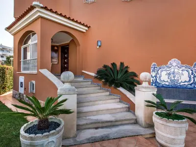 a villa with a swimming pool in front of a house at Villa Vera VIP Properties by Interhome in Vilamoura